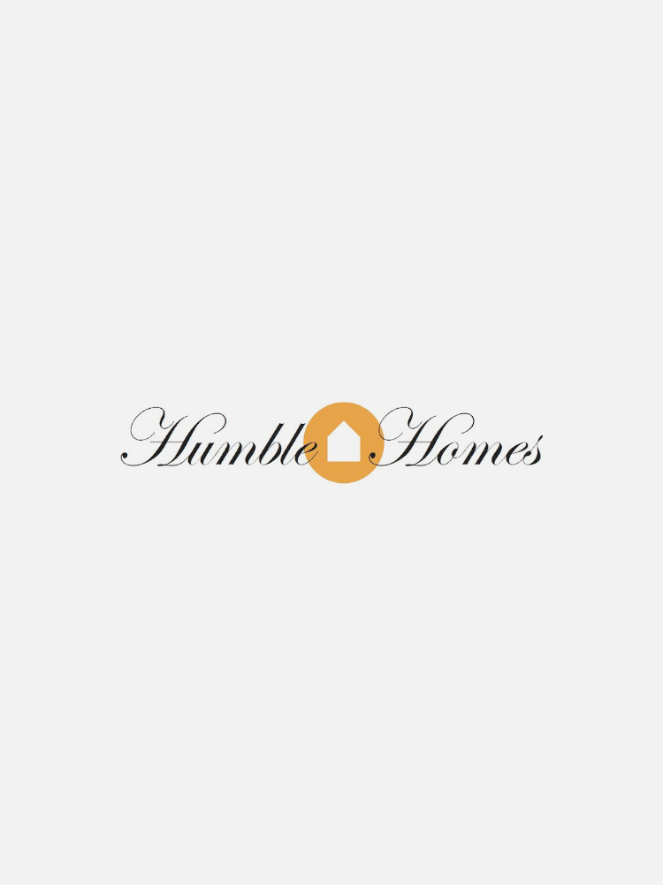 Logo of Humble Homes with the text "Humble Homes" in cursive font and an orange house icon replacing the letter "o" in "Homes.