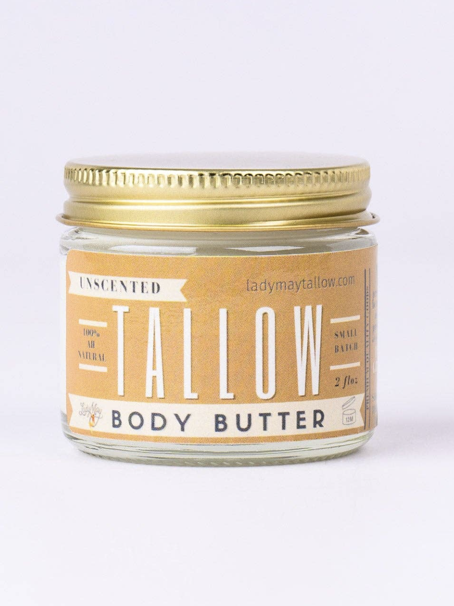 A glass jar of unscented body butter with a gold lid, labeled "Tallow" and "100% natural.