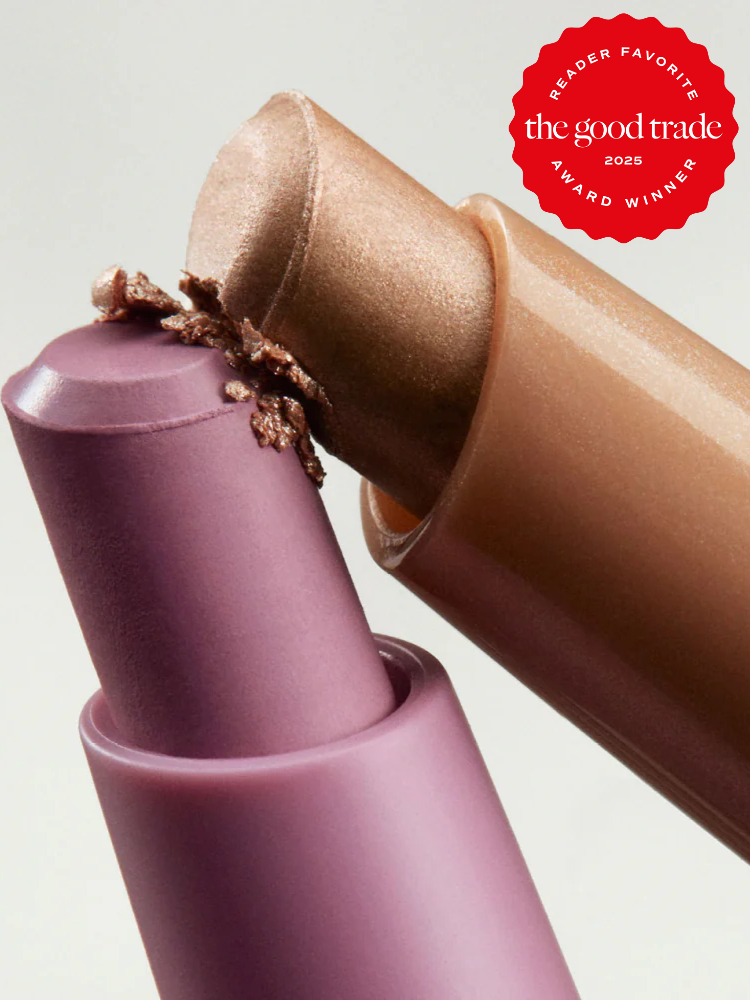 Close-up of two lipstick tubes, one in metallic beige and one in matte mauve, with an award badge in the top right corner reading "The Good Trade 2025 Reader Favorite Award Winner.