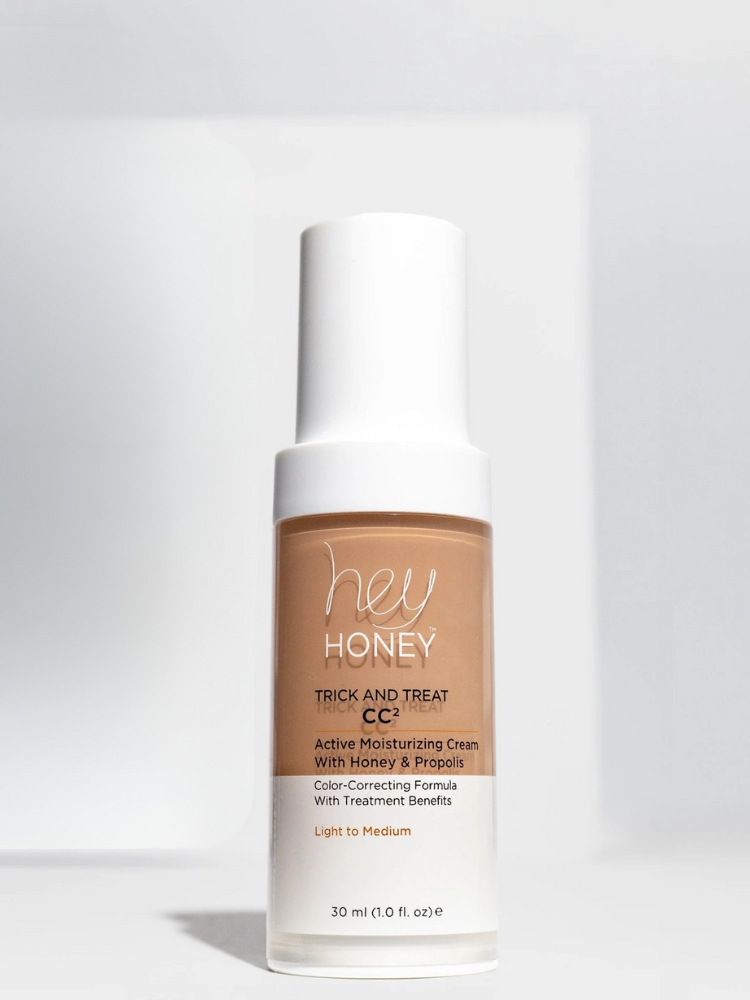 A bottle of Hey Honey Trick and Treat CC2 Active Moisturizing Cream in Light to Medium shade, standing upright against a plain background.