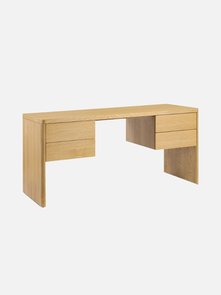A wooden desk with four drawers, two on each side. The desk has a minimalist design with a smooth finish.