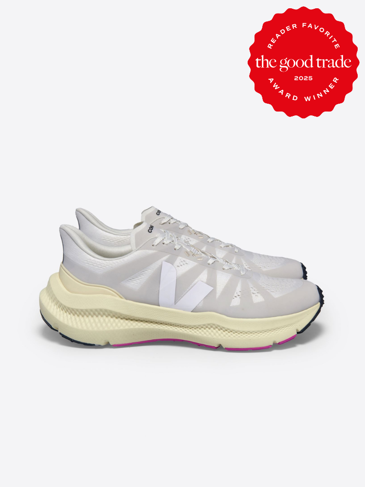 Side view of white athletic shoes with a logo on the side. Red award badge in the corner reads "Reader Favorite, The Good Trade, Award Winner 2023.