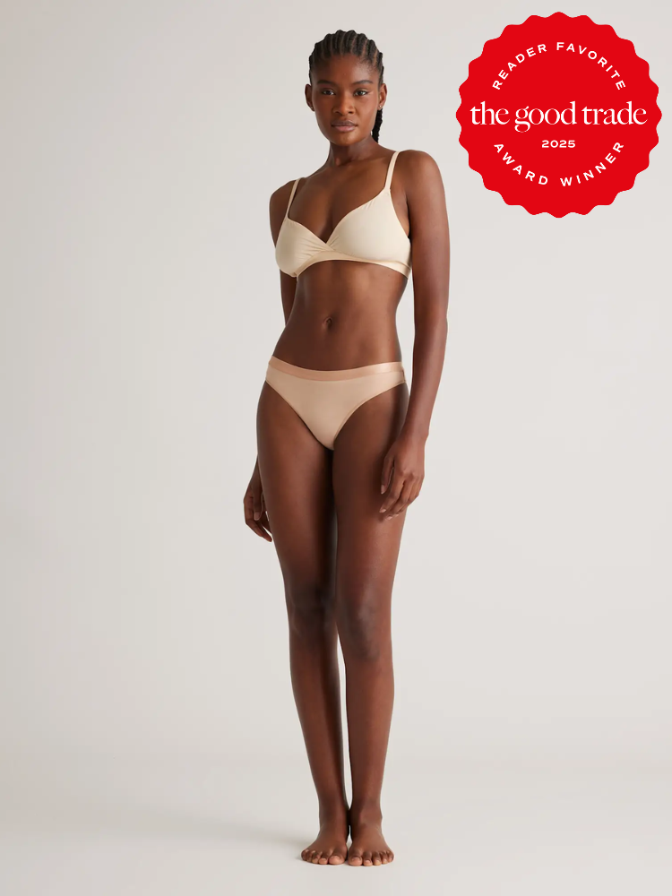 Person in a beige bikini stands against a plain background. A red badge on the top right reads "The Good Trade Reader Favorite Award Winner 2025.