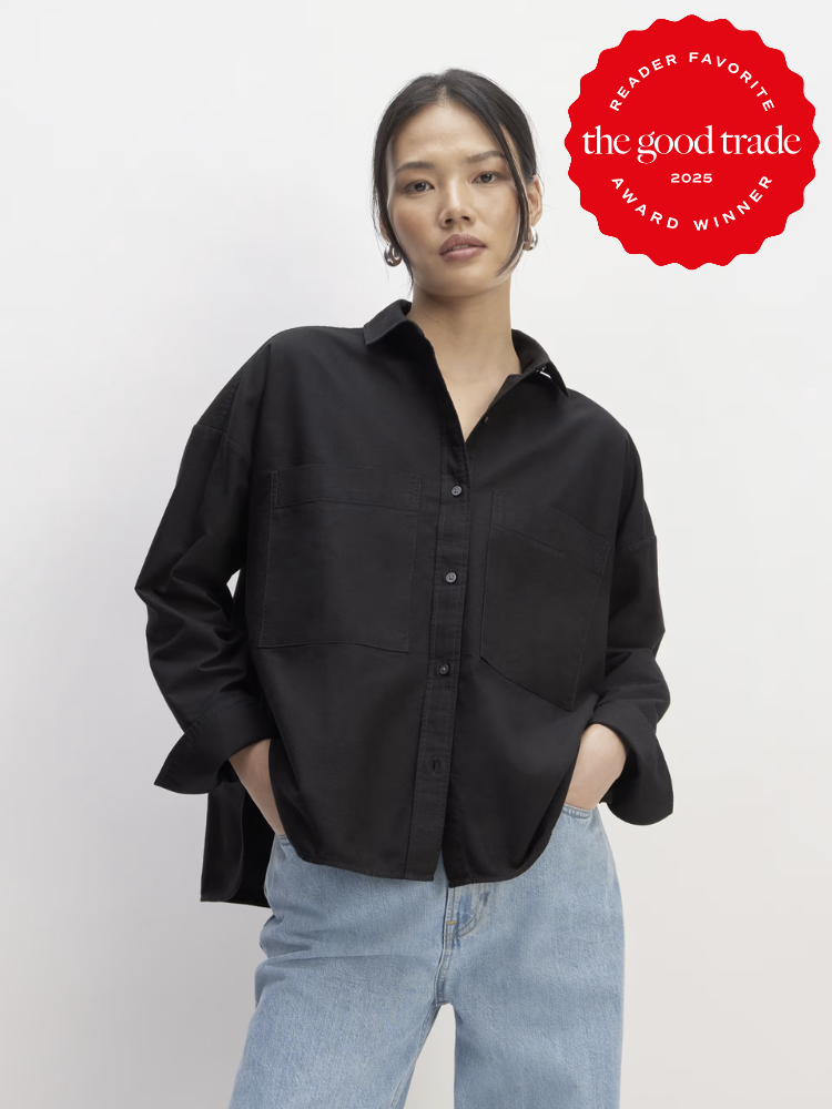 Person in a black button-up shirt and light jeans stands against a plain background. A red "Reader Favorite: The Good Trade Award Winner 2025" badge is in the top right corner.