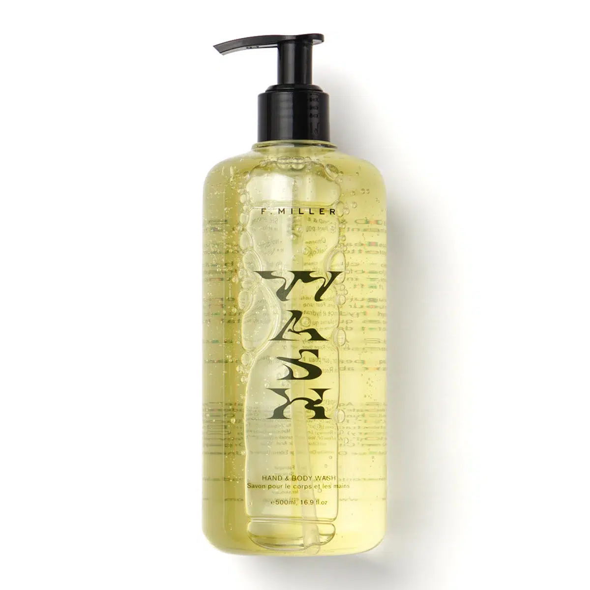Clear bottle of F. Miller hand and body wash with black pump dispenser, containing yellow liquid. The label displays the word "WASH" in large letters.