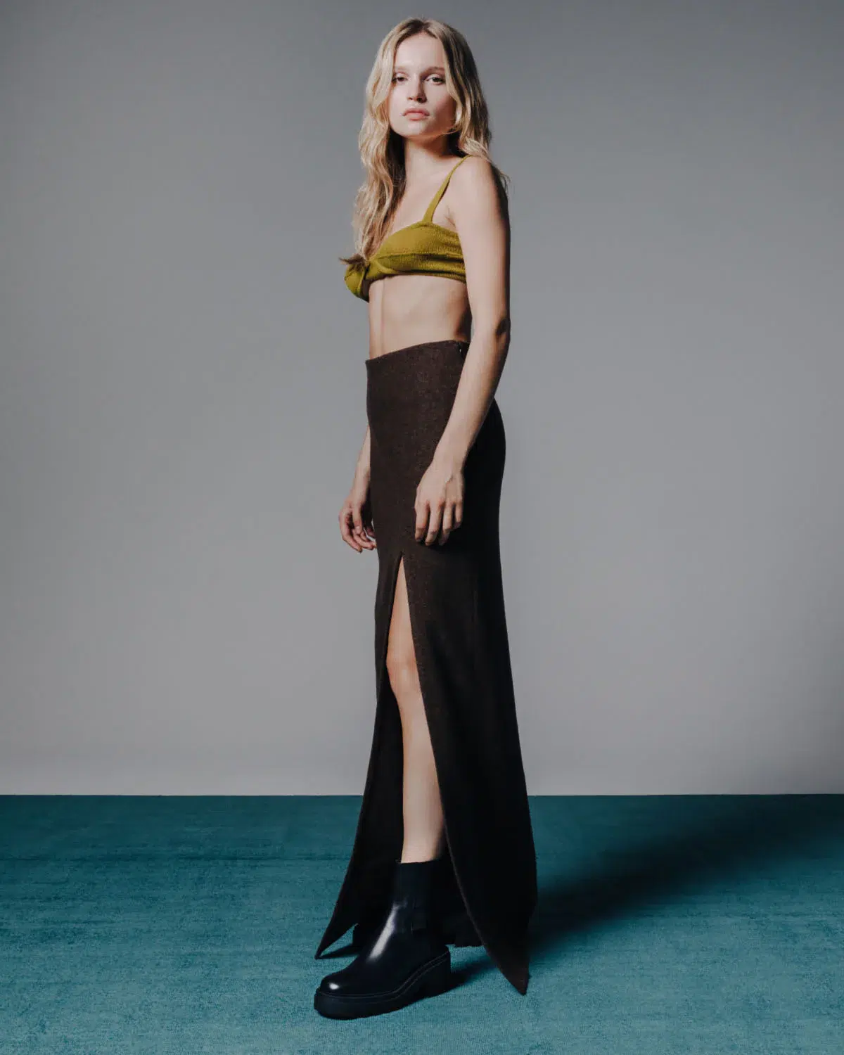 A model in black Koio lug boots. 