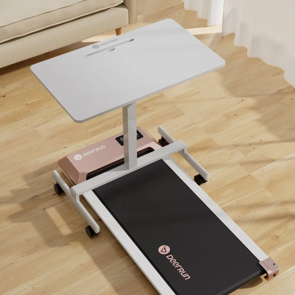 A treadmill desk with a white work surface attached above a treadmill. The setup is on a wooden floor near a sheer curtained window.